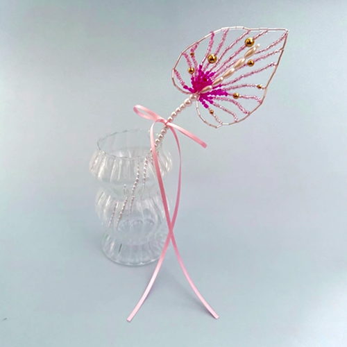 Single beaded anthurium flower inside glass vase