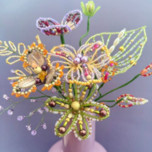 Beaded flower bouquet against purple background