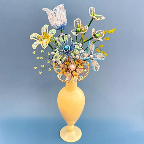 Large white and yellow beaded flower bouquet in yellow vase